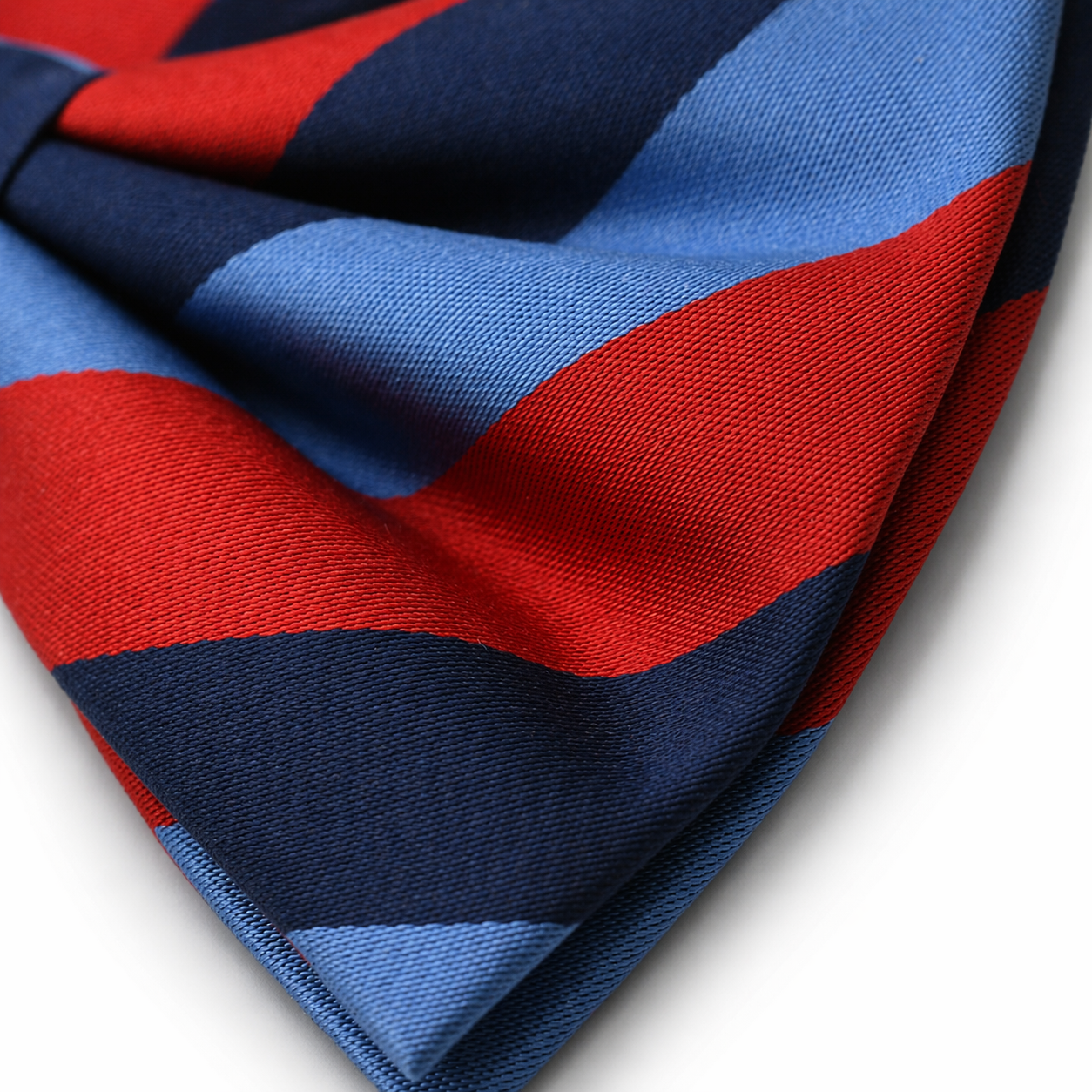 Masonic striped one Journey silk bow  in red, navy, and light blue diagonal pattern, formal Freemason accessory for lodge wear. Close up detailed shot.