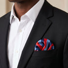 Masonic hankerchief in silk fabric with red, blue, and navy vertical stripes. Being worn in the front suit jacket pocket.