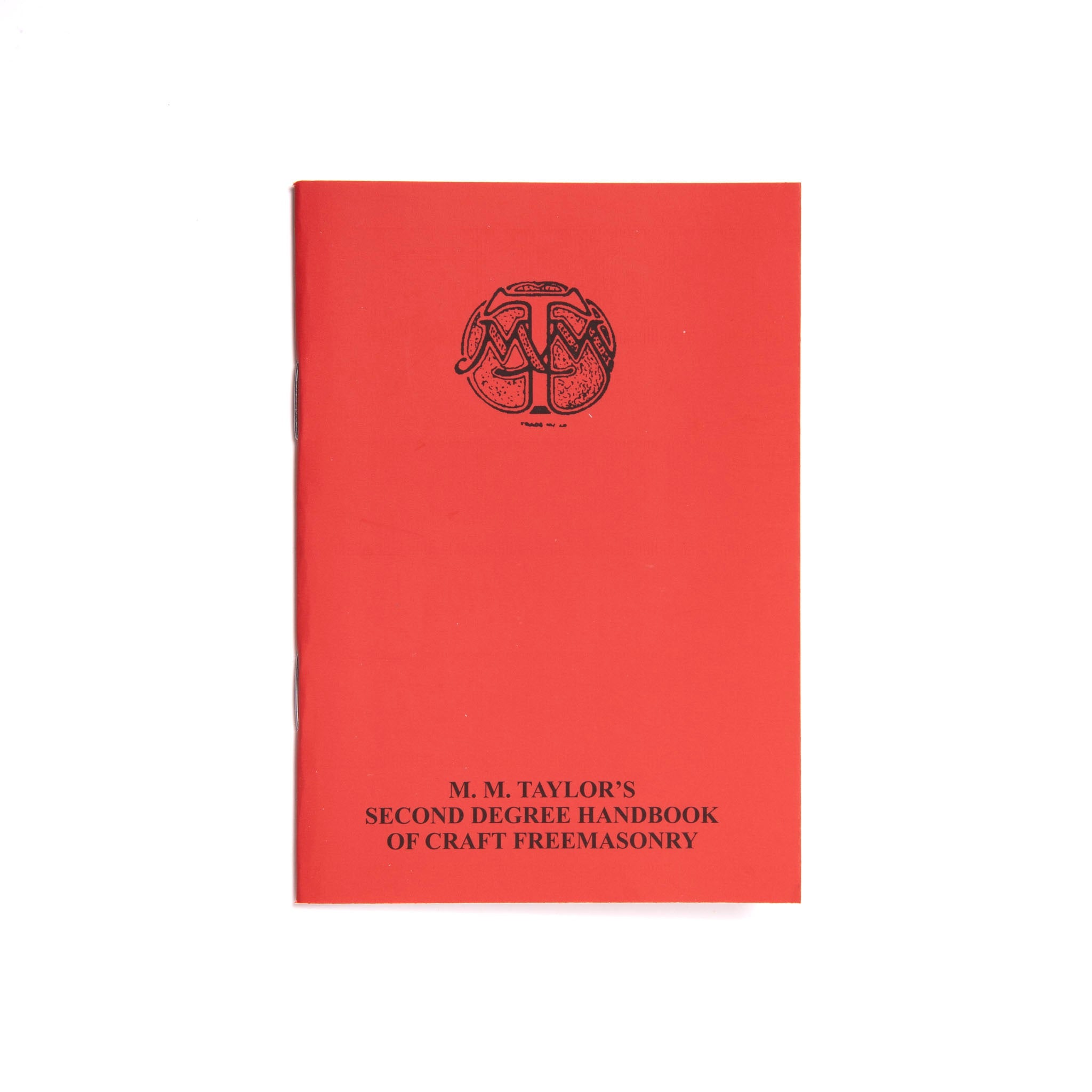A red book with a black cover featuring the title 'M.M. Taylor's 2nd Degree Ritual of Craft Freemasonry' and a Masonic emblem.