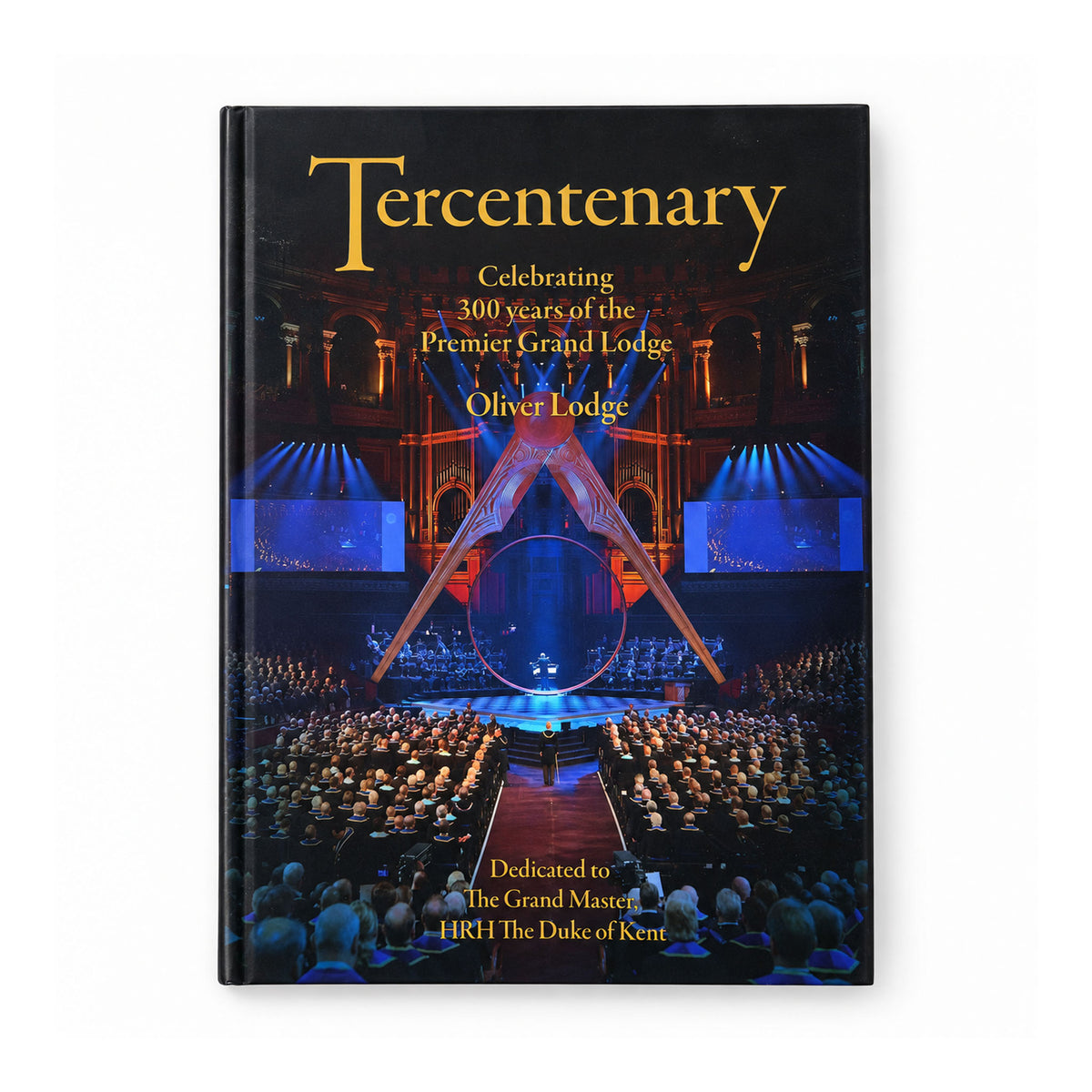 A cover of the book titled 'Tercentenary: Celebrating 300 years of the Premier Grand Lodge' showing an image of a grand ceremony with an audience and stage setup.