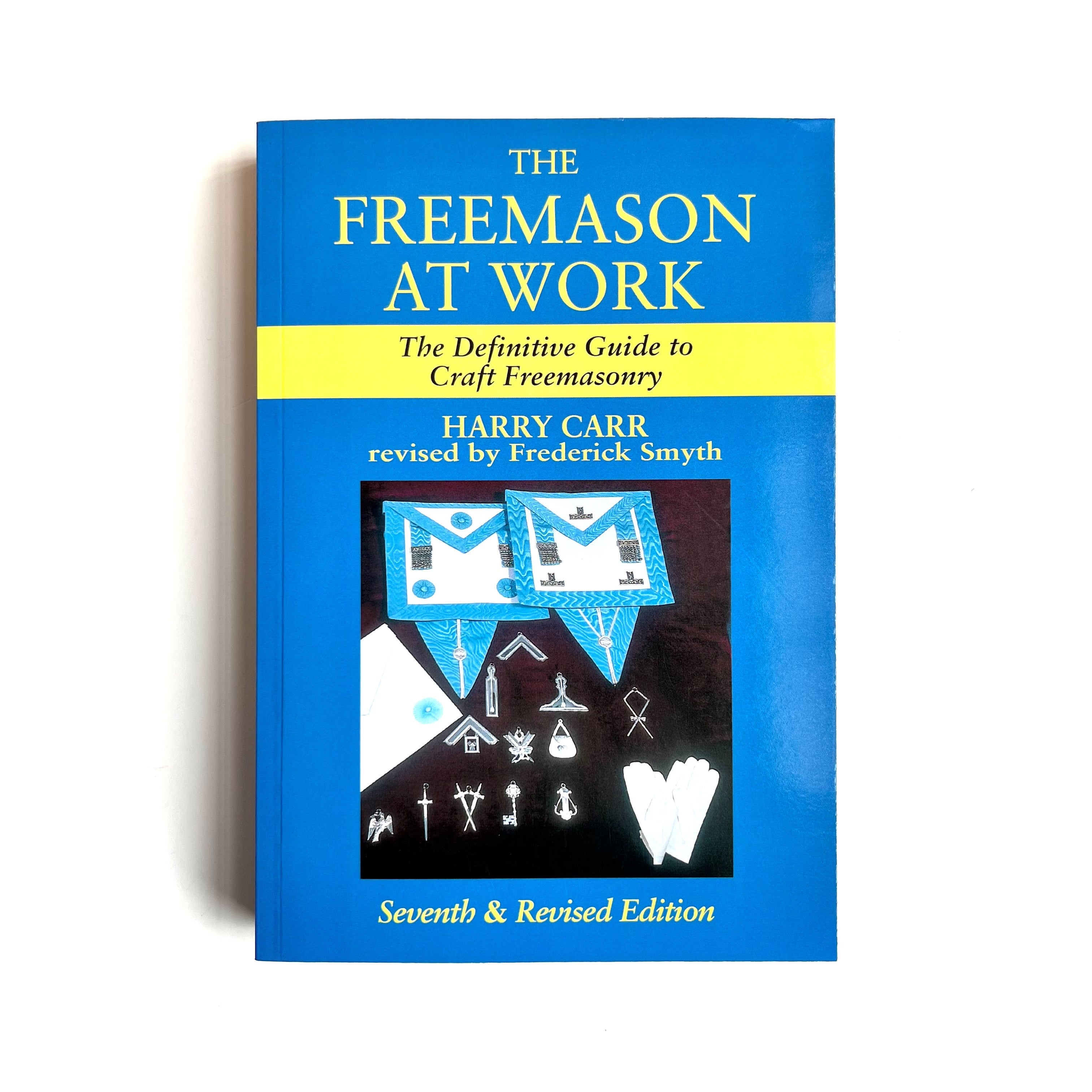 Cover of the book 'The Freemason at Work: The Definitive Guide to Craft Freemasonry' by Harry Carr, revied by Frederick Smyth. The cover features a blue background with the title and author's name at the top, and a graphic design with masonic symbols and mosaic tiles in the lower section.
