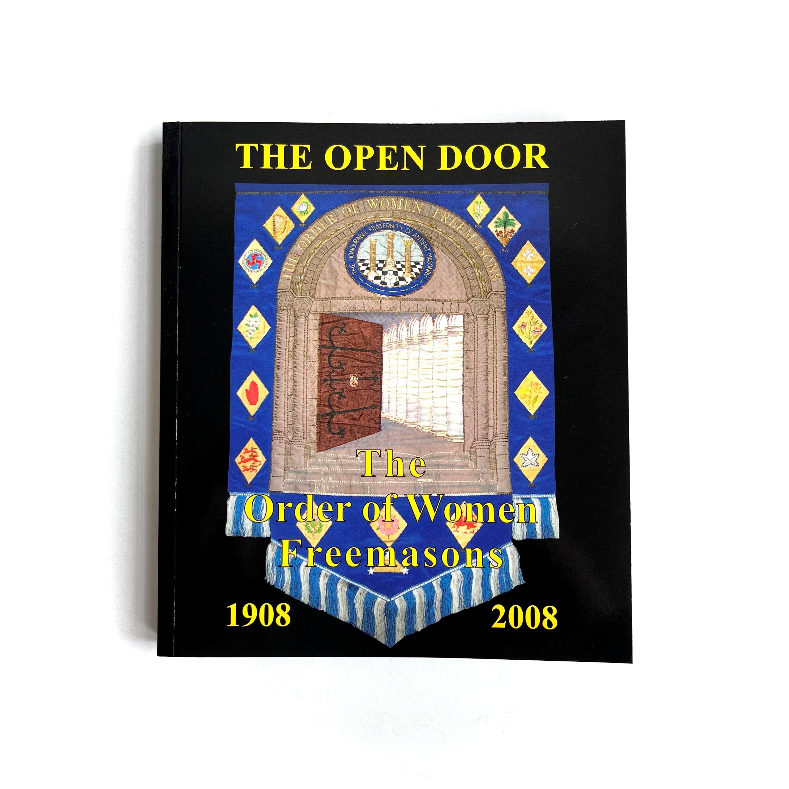 Book titled 'The Open Door' by The Order of Women Freemasons with a decorative cover featuring a door and Masonic symbols.