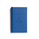 A blue book with an embossed emblem on the cover, titled 'The Revised Ritual'.